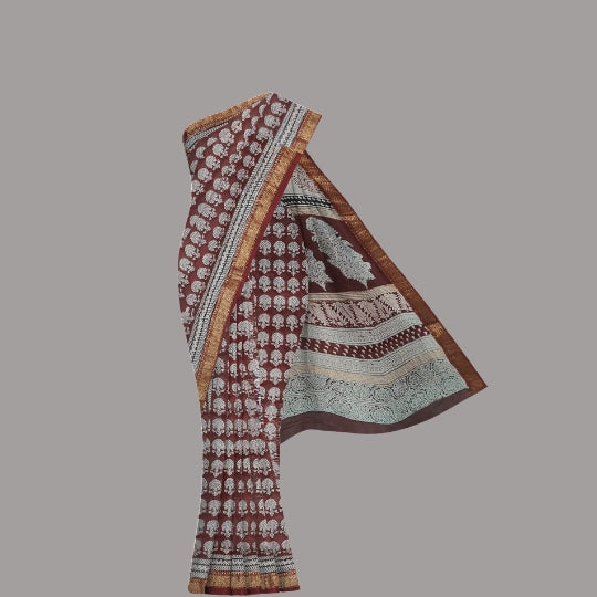 A traditional Indian salwar suit set featuring a maroon cotton kurta with white block prints, a matching printed dupatta, and a brown woven border, displayed against a solid gray background.